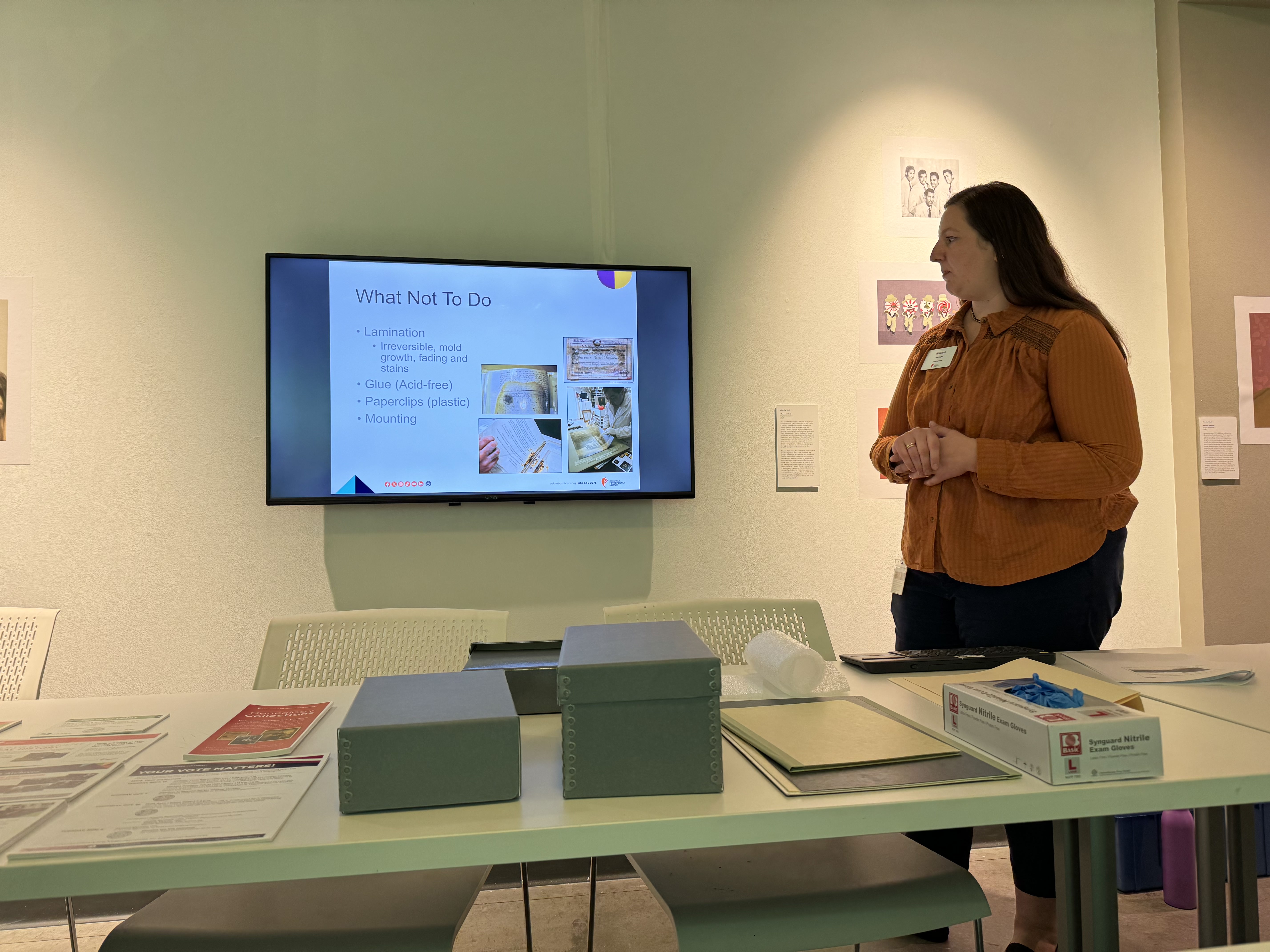 Librarian standing next to a PowerPoint